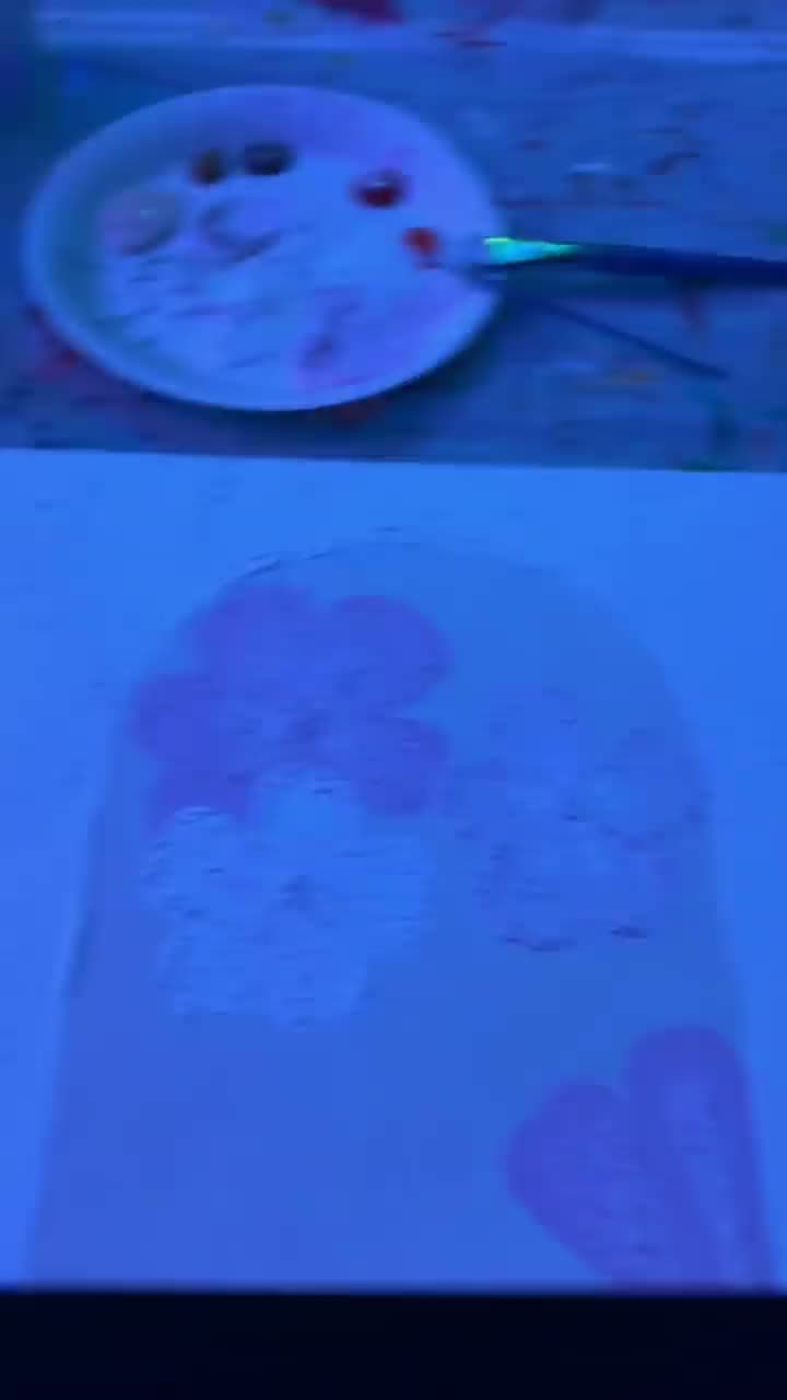 Eine Leinwand wird bei Neonlicht bemalt